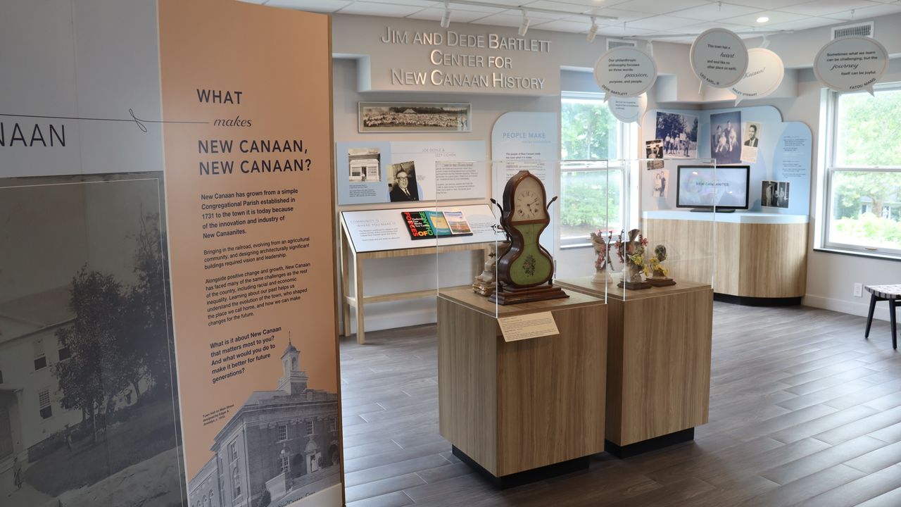 A clock and historical displays inside the Bartlett Center.