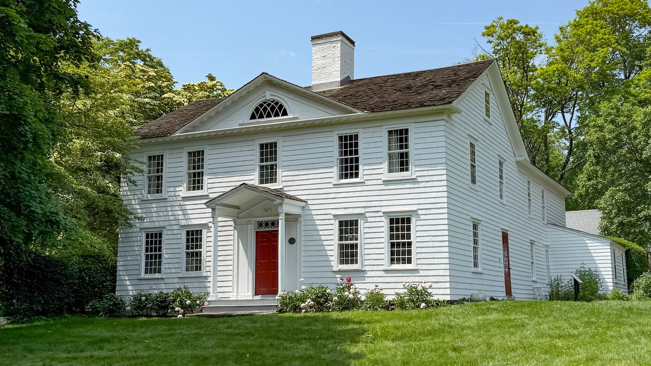 The Hanford-Silliman House with its red front door and green lawn.
