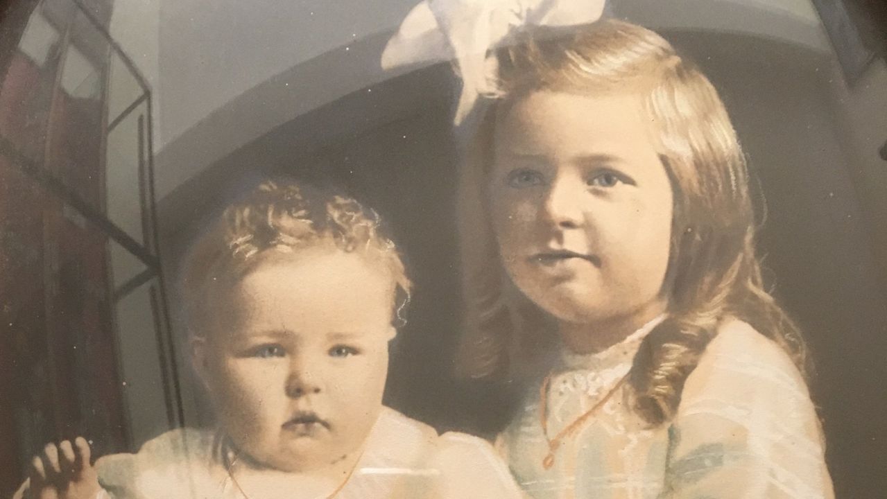 A framed portrait of two children from the Augusta Simon collection.