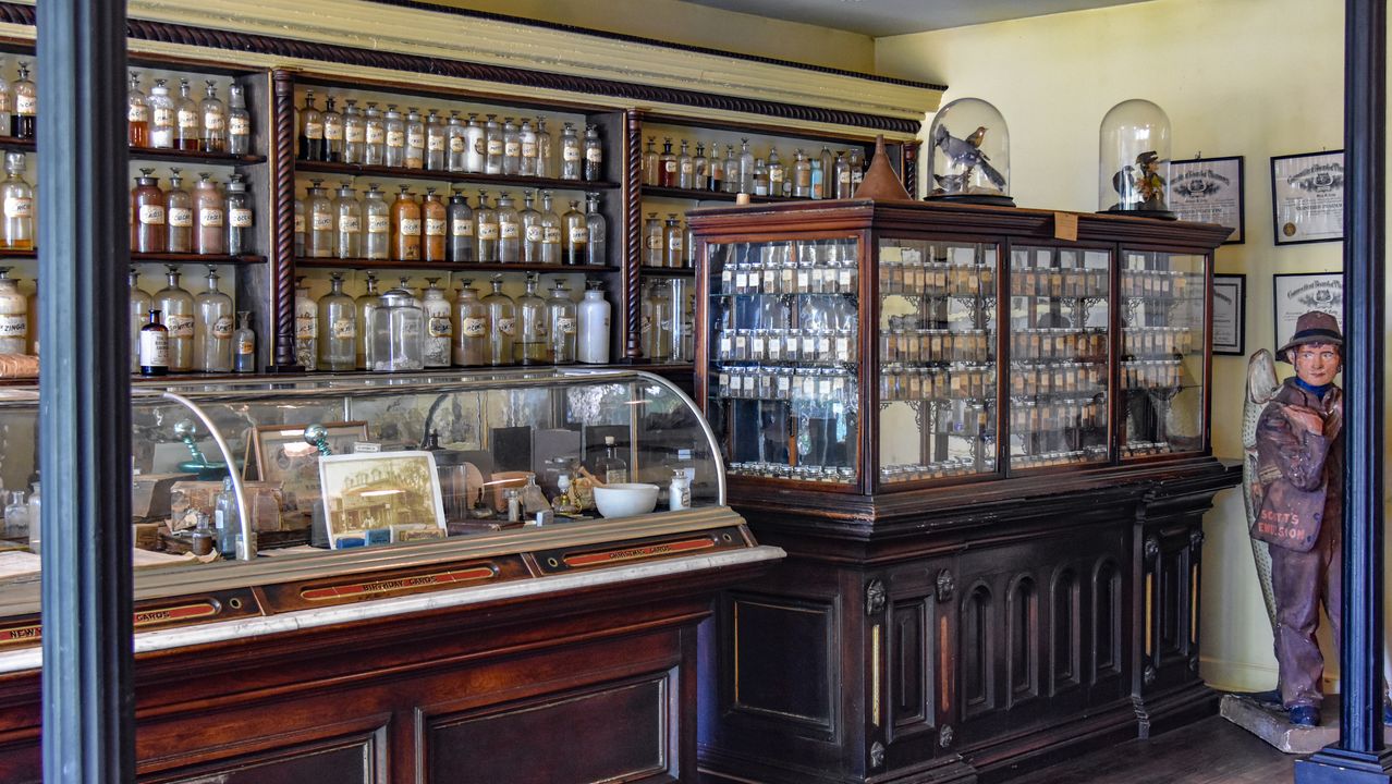 Glass bottles, jars, and display cases in the historic Cody Pharmacy.