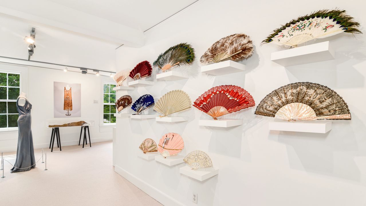 Decorative fans and historic garments in the museum’s clothing and textile collection.